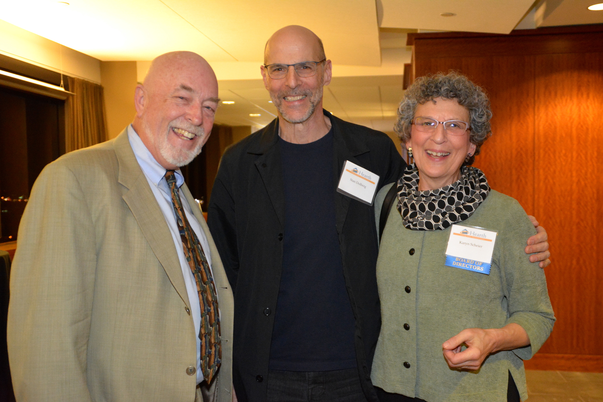  Hearth President &amp; CEO Mark Hinderlie (left) with Board Member Karyn Scheier (right) and her husband Stan Dolberg (center). 