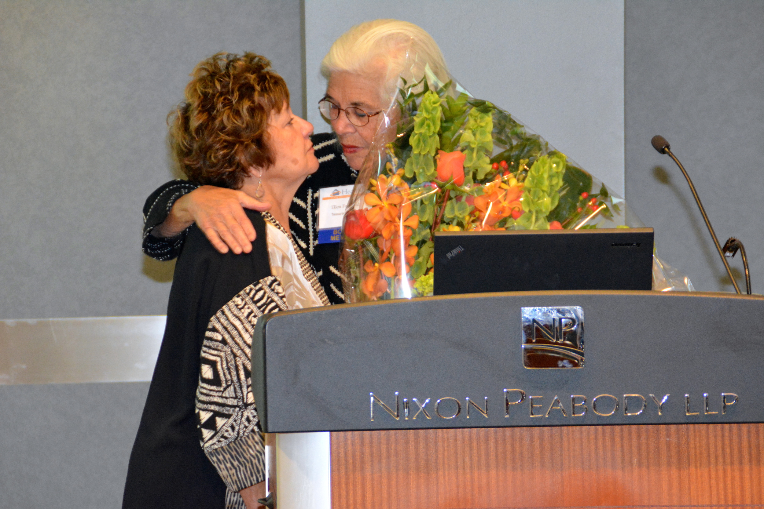  Ellen presents Kathy with flowers. 