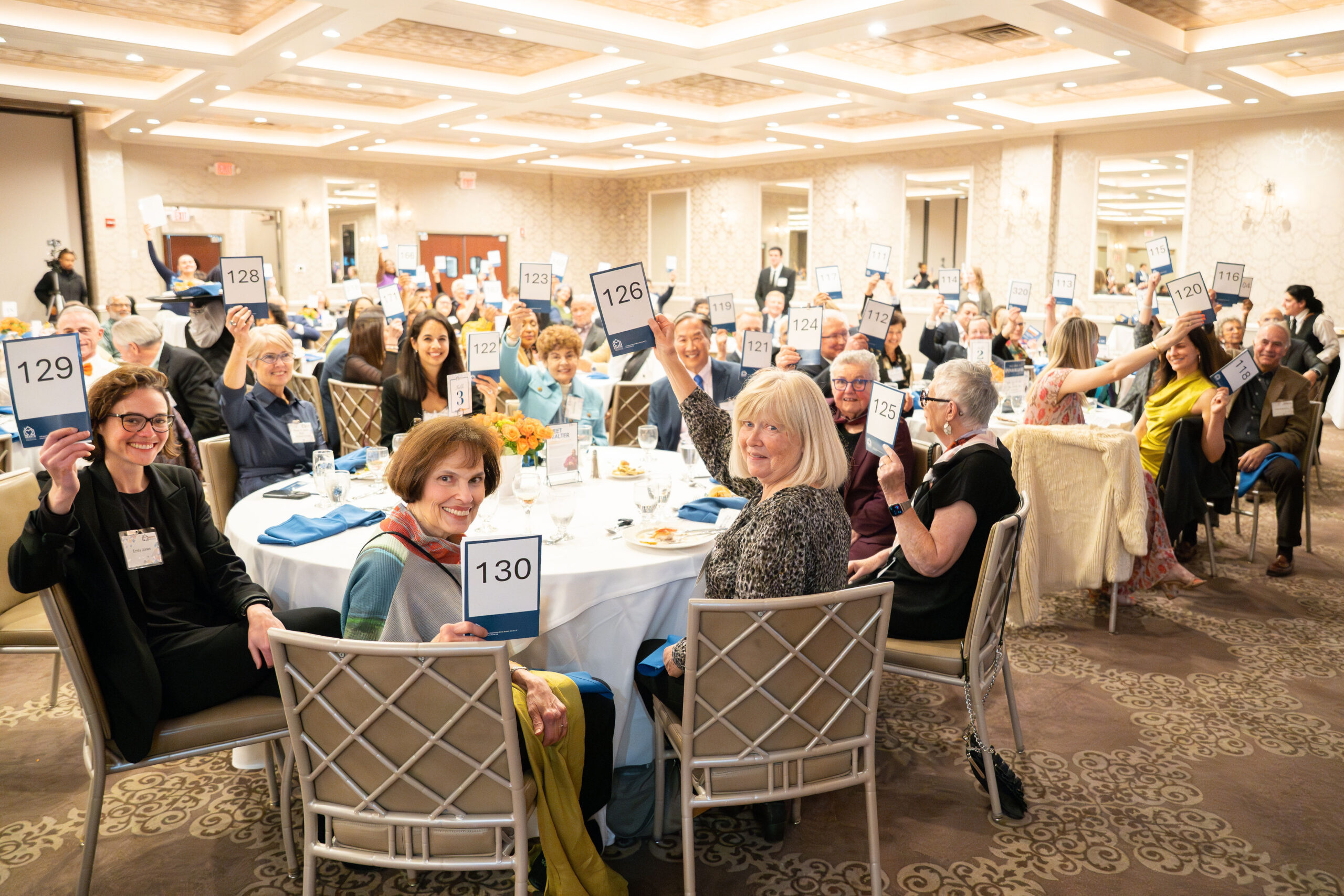 Hearth Home event with people sitting at round tables in a ballroom celebrating progress on the mission of ending older adult homelessness in Boston.