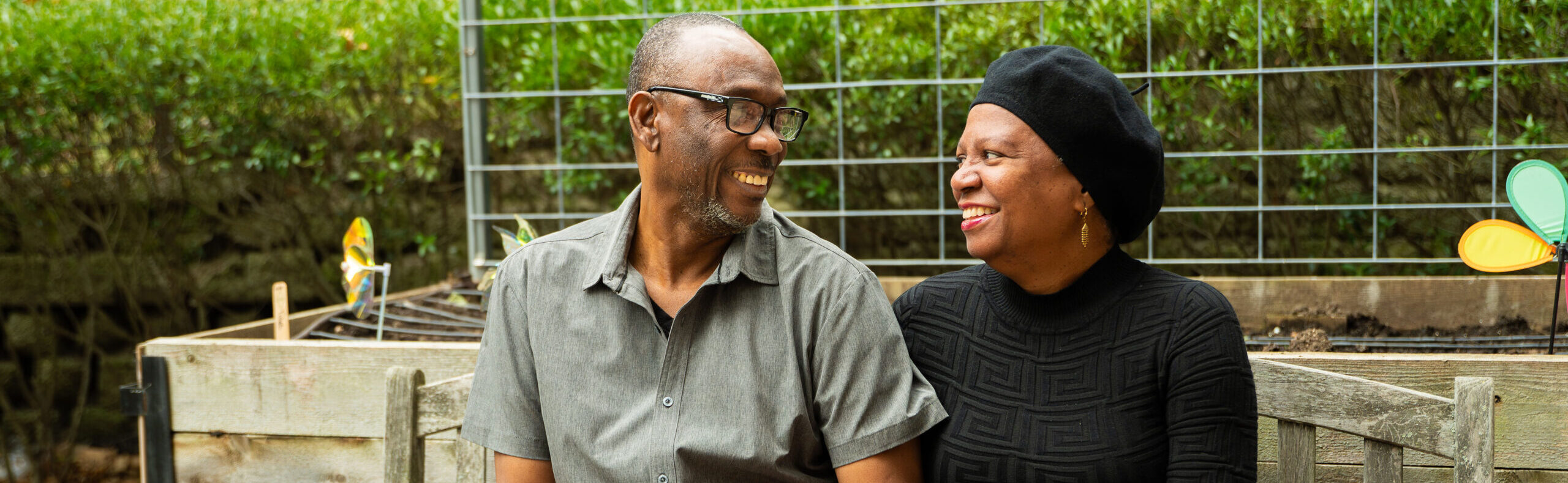 Man and woman looking at each other smiling as participants in Hearth's mission to end older adult homelessness.